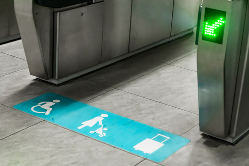 An accessible ticketing gate that would accommodate a person in a wheelchair, a stroller, or a person with luggage