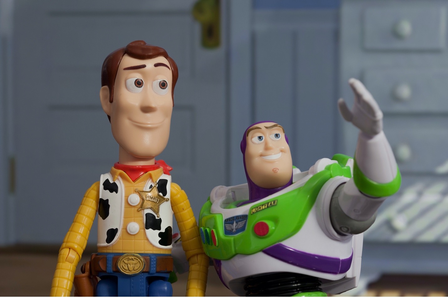 Woody and Buzz Lightyear from "A Toy Story." Buzz's hand is extended forward in reference to his catch phrase: To infinity and beyond.